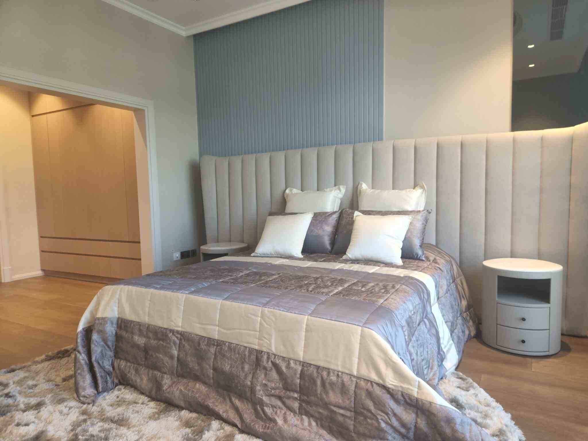 Bedroom with large bed, nightstand - landscaping services in dubai